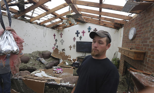 Jeremy Hulce looks through his aunt's home that was destroyed by a tornado in Cleburne, Texas, Thursday, May 16, 2013. 