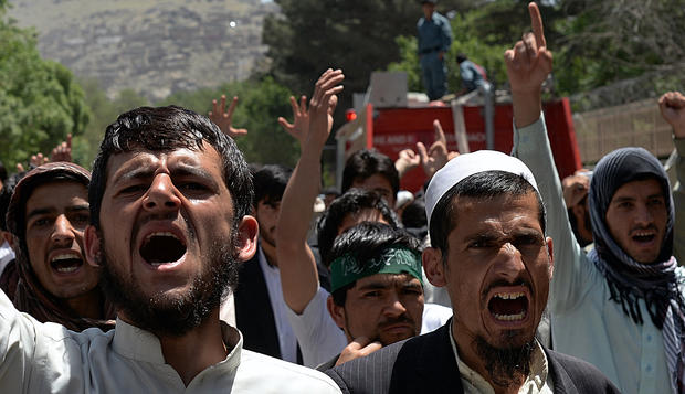 Afghan men chant slogans as they demonstrate against the Elimination of Violence Against Women law 