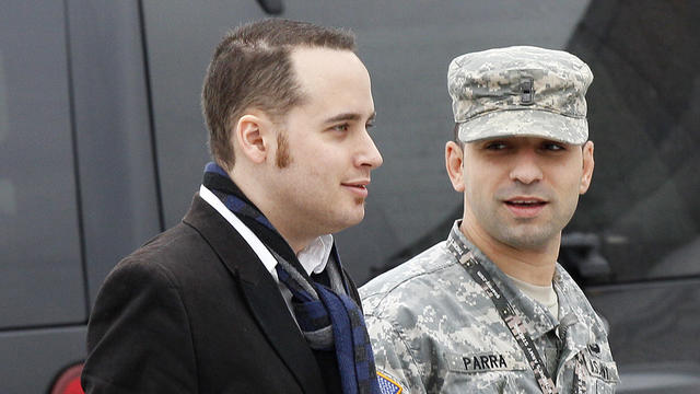 Adrian Lamo, left, walks with a soldier into a courthouse in Fort Meade, Md., Tuesday, Dec. 20, 2011, for a military hearing that will determine if Army Pfc. Bradley Manning should face court-martial for his alleged role in the WikiLeaks classified leaks 