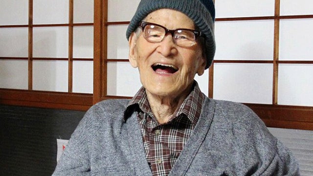 File photo taken in October 2012 and released by Kyotango City shows Jiroemon Kimura smiling after he was presented with certificate as world's oldest living man from Guinness World Records Editor in Chief Craig Glenday 