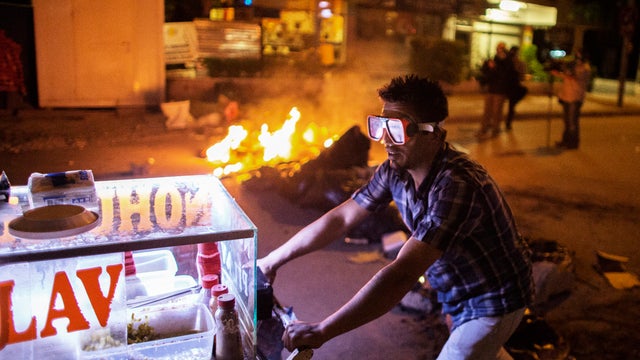 A food street vendor wears a scuba mask to protect himself from tear gas as protesters clashed with Turkish police 