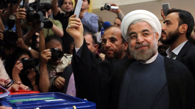 Moderate Iranian presidential candidate Hassan Rowhani casts vote at polling station in Tehran on June 14, 2013 