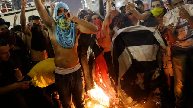 Protestors burn a Sao Paulo state flag in front of City Hall, in Sao Paulo, Brazil 