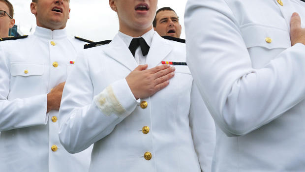 Graduates of the US Naval Academy sing the navy school song during the Naval Academy graduation ceremony at the Navy-Marine Corps Memorial Stadium on May 24, 2013 in Annapolis, Maryland. US President Barack Obama delivered the commencement address. 