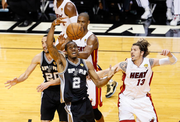 Kawhi Leonard of the San Antonio Spurs grabs the ball against Mike Miller of the Miami Heat in the first quarter during Game 7 of the 2013 NBA Finals at American Airlines Arena on June 20, 2013 in Miami, Florida.  