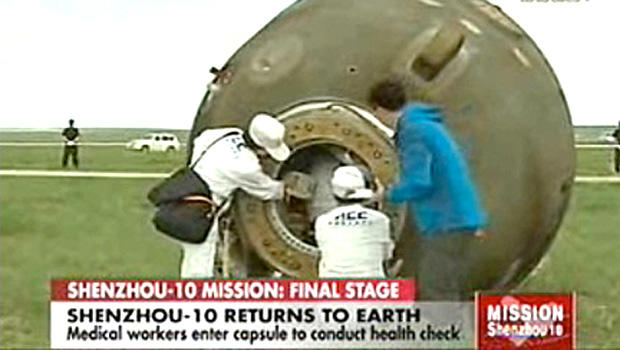 Crew attends to the recently landed Shenzhou 10 spacecraft, carrying three astronauts, as seen on Chinese television on June 25, 2013. 