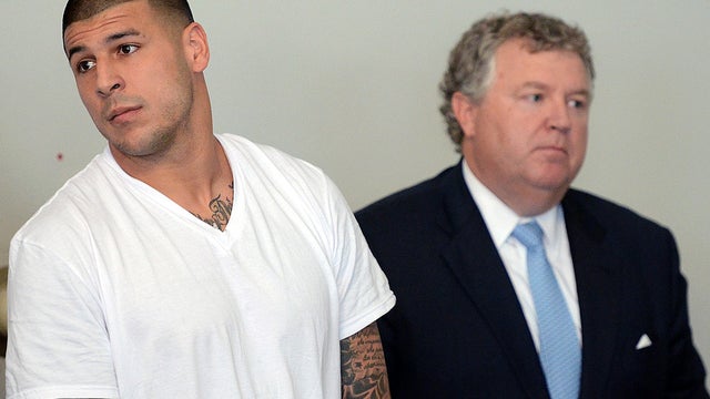 New England Patriots tight end Aaron Hernandez, left, stands with his attorney, Michael Fee, right, during a hearing in Attleboro District Court June 26, 2013, in Attleboro, Mass. 