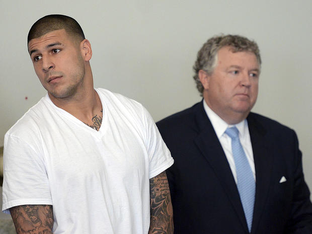 New England Patriots tight end Aaron Hernandez, left, stands with his attorney, Michael Fee, right, during a hearing in Attleboro District Court June 26, 2013, in Attleboro, Mass. 