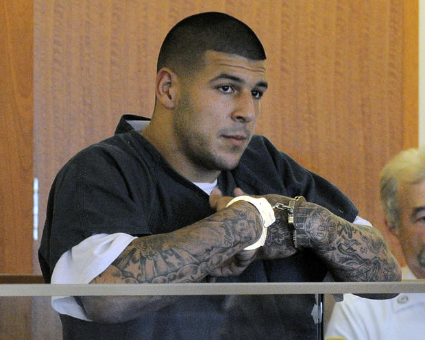 New England Patriots tight end Aaron Hernandez, left, stands with his attorney, Michael Fee, right, in Attleboro District Court June 26, 2013, in Attleboro, Mass. 