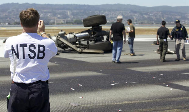 This photo released the National Transportation Safety Boards shows an NTSB officer at the scene where an Asiana Airlines flight crashed at San Francisco International Airport. 
