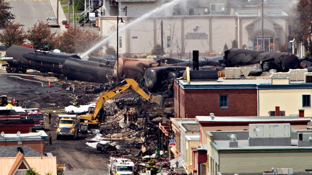 Searchers dig through the rubble for victims of a train derailment in Lac-Megantic, Quebec 