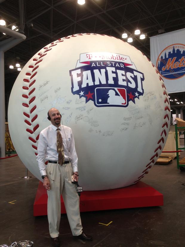 WCBS 880's Peter Haskell poses with the world's largest baseball 