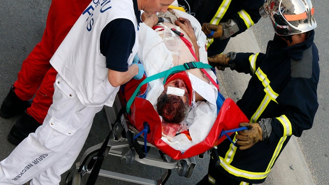 Rescue workers transport a victim from a train that derailed in Bretigny-sur-Orges, France, south of Paris July 12, 2013. 