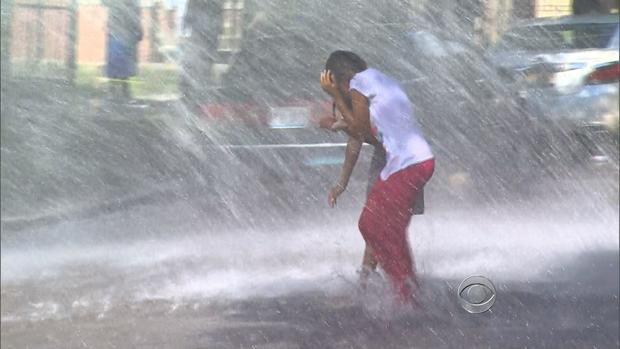 A child find relief from triple-digit weather in Chicago by running through water on July 17, 2013. 