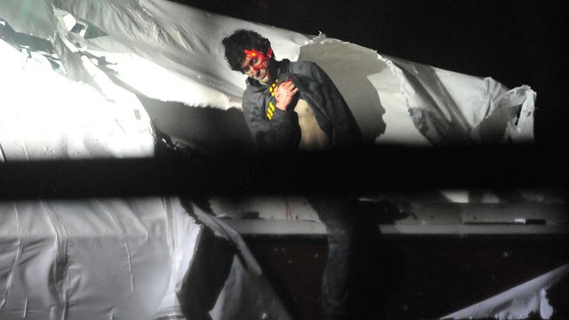Dzhokhar Tsarnaev emerges from the boat he was hiding in in Watertown, Mass. 