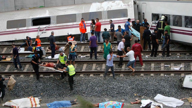 Emergency personnel at scene of train derailment in Santiago de Compostela, Spain, Wednesday 