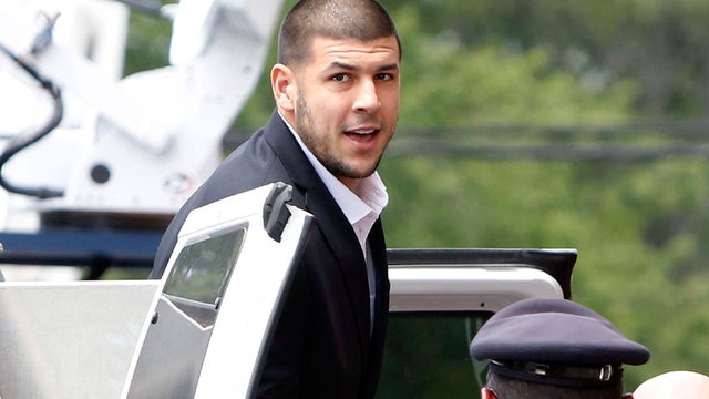 New England Patriots tight end Aaron Hernandez, left, stands with his attorney, Michael Fee, right, during a hearing in Attleboro District Court June 26, 2013, in Attleboro, Mass. 