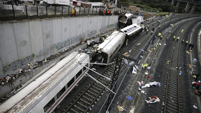 Rescuers, forensics and police officers work at site of train accident near Santiago de Compostela, Spain, July 25, 2013 