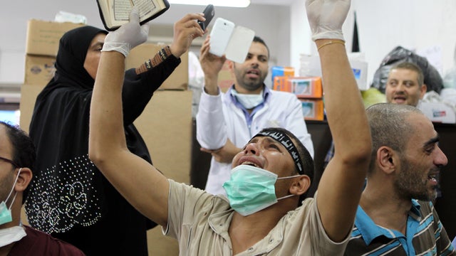 An Egyptian man mourns the death of a relative, shot dead in the Egyptian capital Cairo after violence erupted overnight, inside a Muslim Brotherhood field hospital July 27, 2013. 
