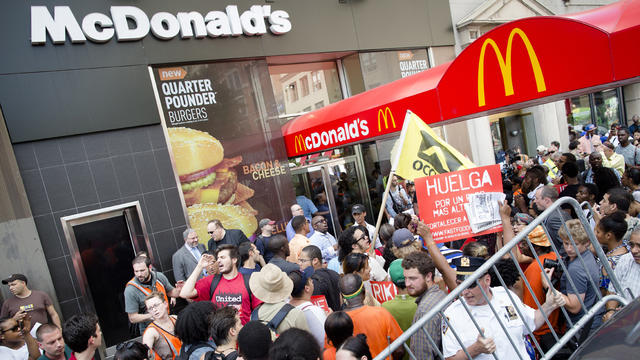 Demonstrators in support of fast food workers protest outside a McDonald's as they demand higher wages and the right to form a union without retaliation Monday, July 29, 2013, in New York's Union Square.  