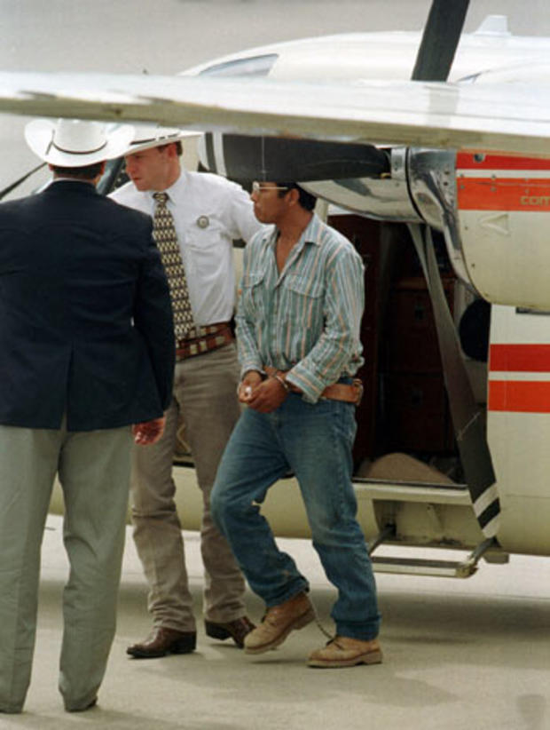 Accused serial killer Angel Maturino Resendiz, led by Sgt. Drew Carter of the Texas Rangers, arrives at Hobby Airport in Houston on Tuesday, July 13, 1999, after turning himself in to Carter in El Paso. 