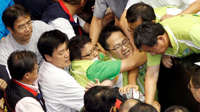 Ruling and opposition lawmakers fight on the legislature floor in Taipei, Taiwan, Aug. 2, 2013. 