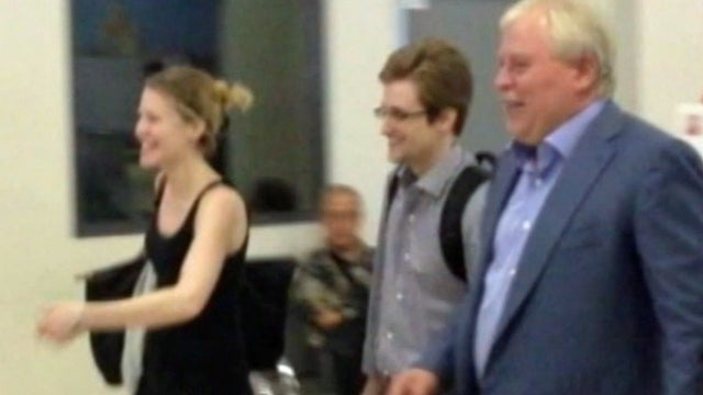 Edward Snowden (center) leaving Moscow's Sheremetyevo airport with lawyer Anatoly Kucherena (right) and WikiLeaks representative Sarah Harrison 
