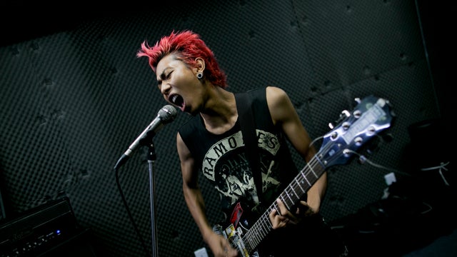 In this July 9, 2013 photo, Kyaw Kyaw, lead singer of punk rock band Rebel Riot, rehearses with his group members in a Yangon studio, Burma. 