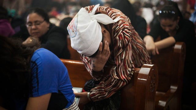An Egyptian Coptic Christian woman prays in a church within Al-Mahraq Monastery in Assiut, Upper Egypt. 
