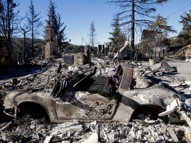 The remains of a home and a car destroyed by the Silver wildfire are seen Aug. 9, 2013, near Banning, Calif. 