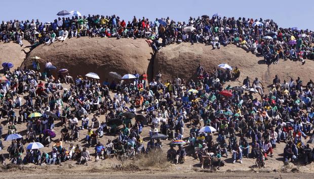 People attend a commemoration service for the striking platinum miners that were killed a year ago, in Marikana 