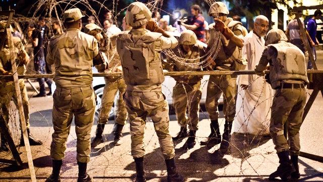 Egyptian army soldiers take out barbed wire that was surrounding the Supreme Constitutional Court in Cairo 
