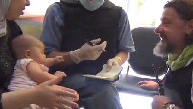 U.N. weapons inspector interviewing a woman at a clinic in the eastern Ghouta suburbs of Damascus 