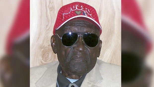 In this 2011 photo provided by the Pine Bluff Commercial, Monroe Isadore poses for photos on his 105th birthday in Pine Bluff, Ark.  