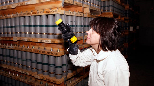 Chemical Operations Manager Debra Michaels uses a flashlight to inspect mustard agent shells in one of the bunkers at the Army's Pueblo Chemical Depot in Pueblo, Colo., Jan. 21, 2010. 
