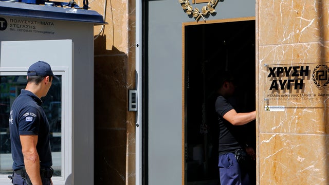 A policeman guards the headquarters of Greece&acirc; 