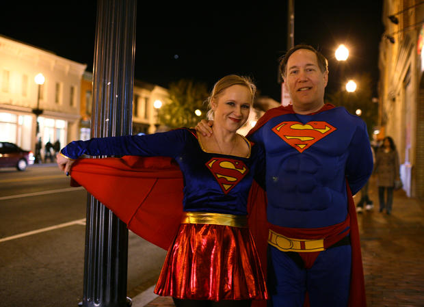 A couple with the Superman and Supergirl 