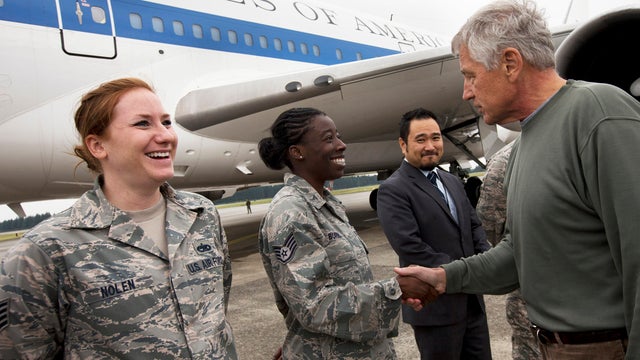 U.S. Air Force Staff Sgt. Sheri Nolen, left, and Staff Sgt. Denise Burris are greeted by U.S. Secretary of Defense Chuck Hagel as he leaves Japan to return to the U.S. from Yokota Air Base Oct. 4, 2013, ending his trip to South Korea and Japan. 