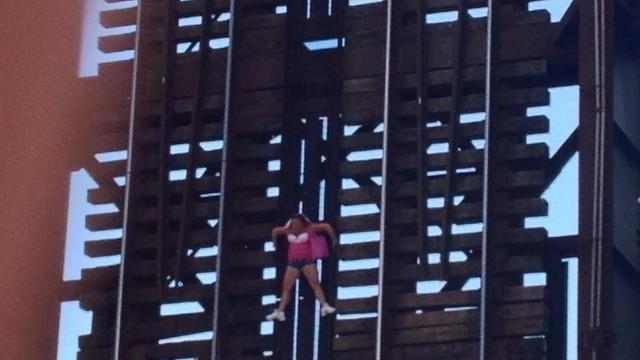 woman-dangling-from-bridge.jpg 