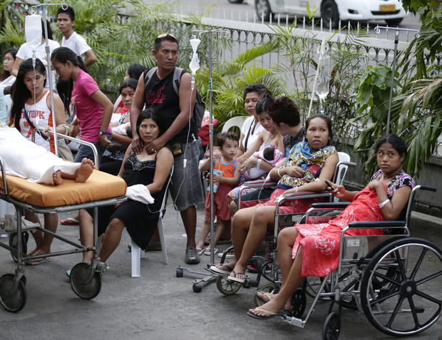 Patients stay outside a hospital to avoid aftershocks following a 7.2-magnitude earthquake that hit Cebu city in central Philippines, Tuesday, Oct. 15, 2013. 