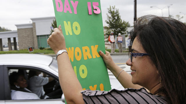 Tania Carreon, a furloughed federal worker, protests in Cincinnati on Tuesday, Oct. 15, 2013. 