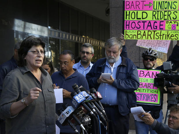 Roxanne Sanchez, left, president of Service Employees International Union Local 1021, speaks during a news conference 