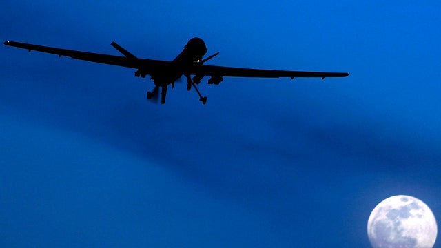 In this 2010 file photo, an unmanned U.S. Predator drone flies over Kandahar Air Field, southern Afghanistan, on a moonlit night.  