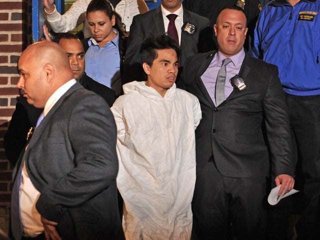 Mingdong Chen, a suspect in the murder of a five people in Brooklyn's Sunset Park neighborhood, is walked by police from the 66th precinct, Sunday, Oct. 27, 2013 in New York. The Chinese immigrant, who neighbors said struggled to survive in America, was arrested in the stabbing death Saturday night of his cousin's wife and her four children. 