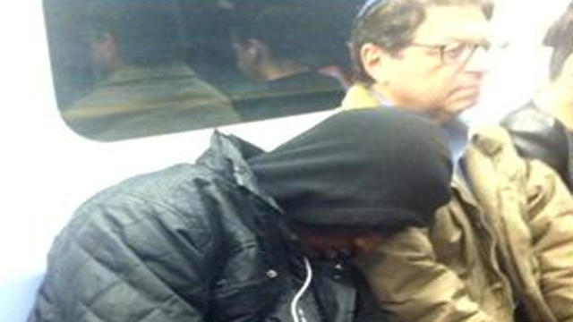 q-train-rider-sleeps-on-strangers-shoulder.jpg 