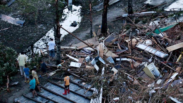 Residents sift through the rubble of their damaged house following a powerful typhoon that hit Tacloban on hardest-hit Leyte Island in the Philippines Nov. 9, 2013. 