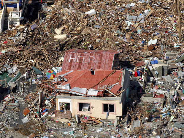 An aerial view shows signs for help and food amid the destruction left from Typhoon Haiyan in the coastal town of Tanawan, Philippines, Nov. 13, 2013. 