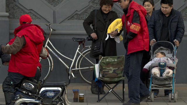 A child rests in a stroller on the streets of Beijing 