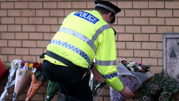 A Scottish police officer is seen at the scene Nov. 30, 2013, following a helicopter crash at the Clutha Bar in Glasgow, Scotland. 