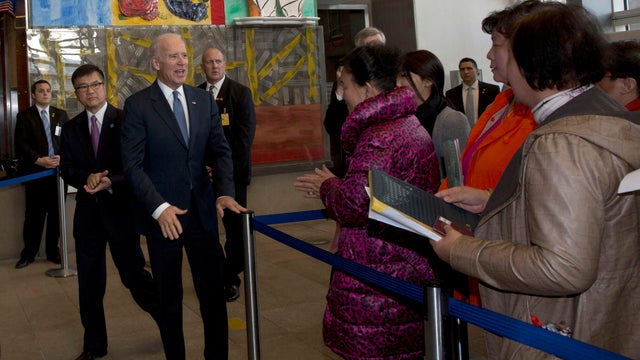 Vice President Joe Biden and U.S. ambassador to China Gary Locke, second from left, meet visa applicants at the U.S. Embassy in Beijing 